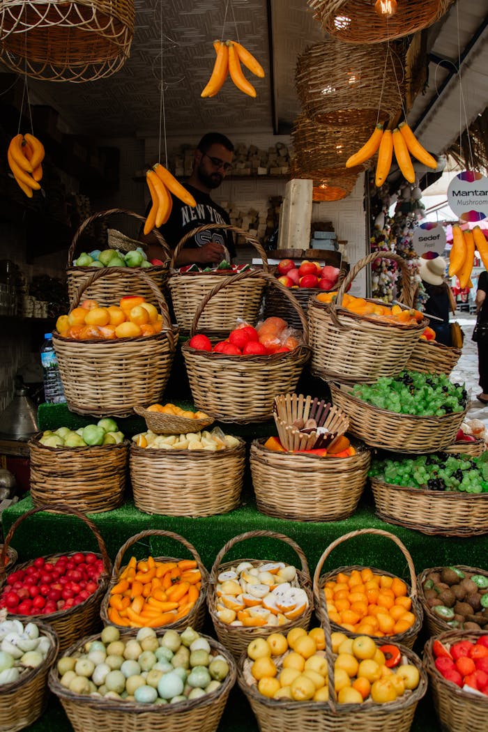 A vibrant display of fresh fruits and vegetables in wicker baskets at an outdoor market.